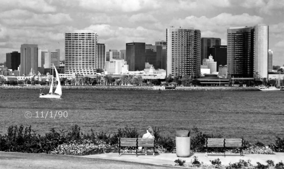 B/W photo: View of San Diego skyline with bay and Coronado park benches in foreground - Embedded text: 11/1/90