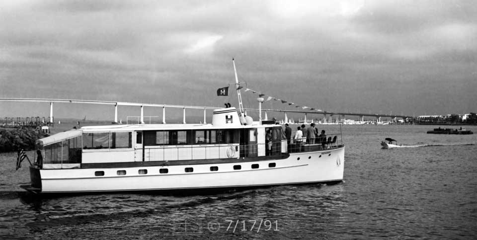 B/W photo: A yacht for hire exiting marina channel onto San Diego Bay - Embedded text: 7/17/91