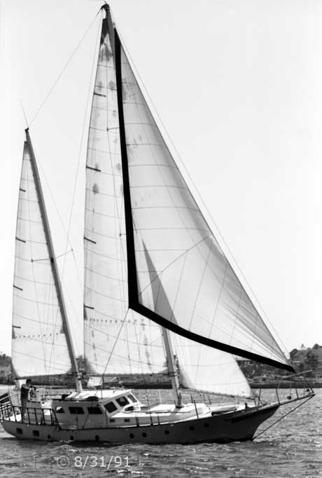 B/W photo: Starboard view of boat under sail with Coronado in background - Embedded text: 8/31/91