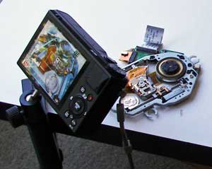 Color photo: Setup used to photograph 'focus stack' view of portable DVD drive mechanism