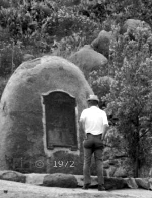 B/W image: 6 foot man in front of monument